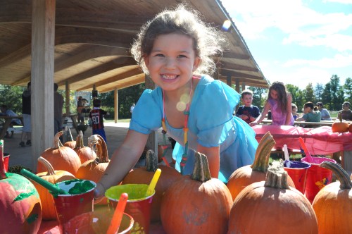 4 year-old Naomi Lipson of New Paltz paints a pumpkin at last Saturday's New Paltz Central School District's Foundation for Student Enhancement kids event at the Field of Dreams.